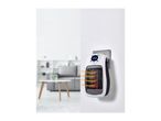 Plug-in ceramic heater with digital display, emitting heat, in a living room setting.