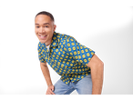 A man wearing a blue short-sleeve shirt with a yellow Lidl logo pattern, smiling at the camera.