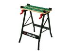 Portable workbench with a green patterned surface and red handles.