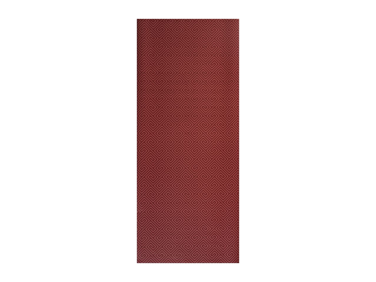 A rectangular red mat with a repeating geometric spiral pattern.