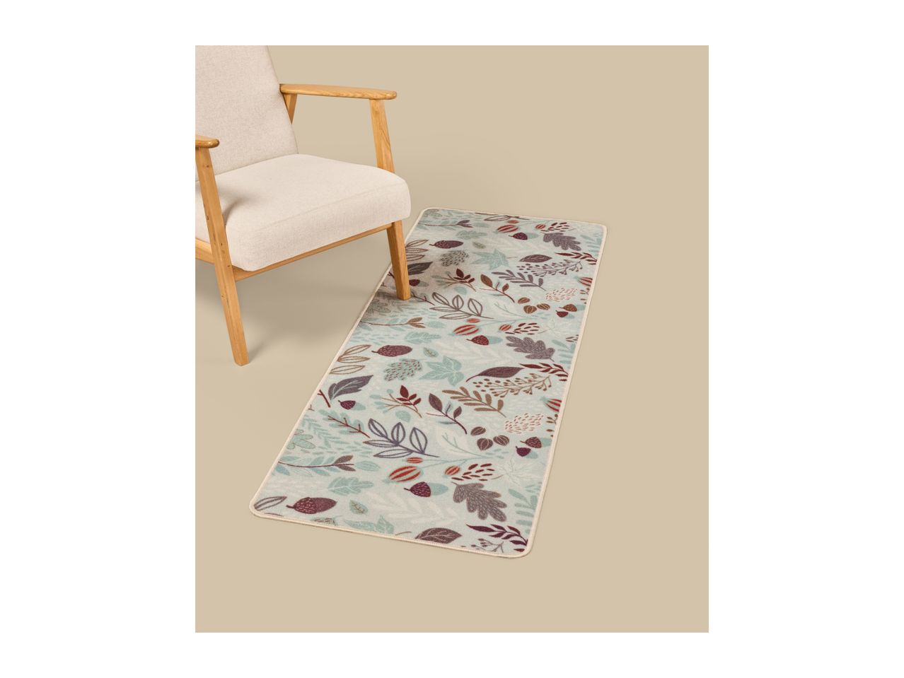 A beige armchair next to a runner rug with a fall-themed leaf and acorn pattern.