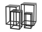 Four black metal nesting tables of varying heights and sizes