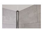 Close-up of a black shower door corner post against a gray tiled wall.