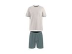 A light beige t-shirt with a pocket and dark teal shorts.
