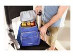 Man packing a blue cooler backpack with fruit and a stainless steel water bottle.