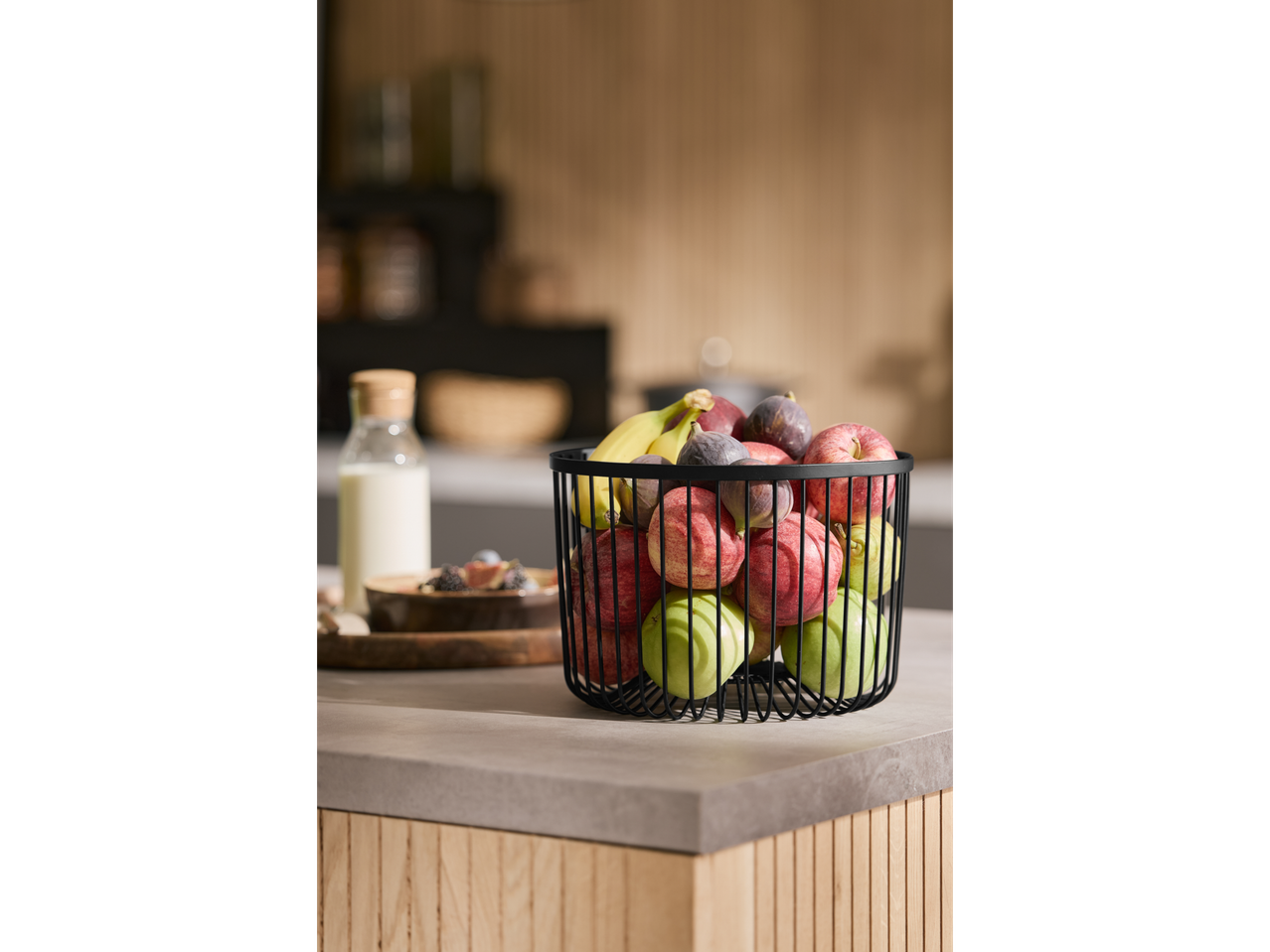 SILVERCREST® Fruit Basket filled with apples, figs, and bananas on a kitchen counter.