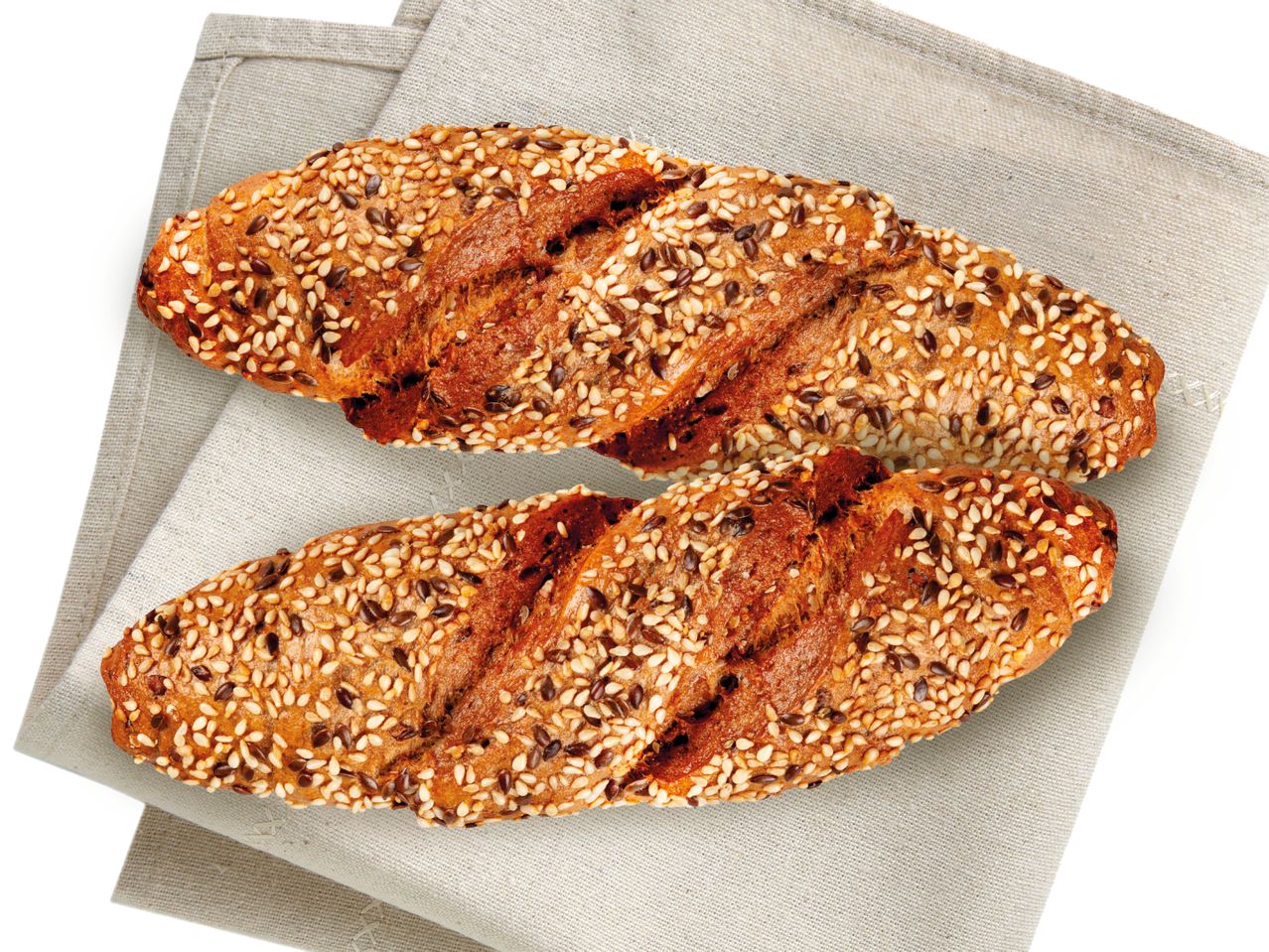 Sesam- und Mischkornbrötchen auf Stoffserviette.
