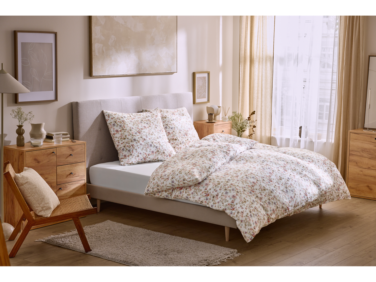 Livarno Sateen Fitted Sheet on a bed with floral duvet and pillows in a bedroom.