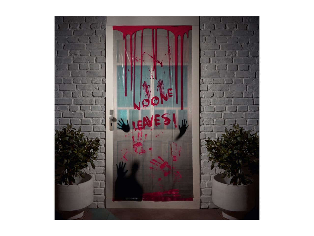 Halloween door decoration with fake blood, handprints, and the text 'NO ONE LEAVES!'