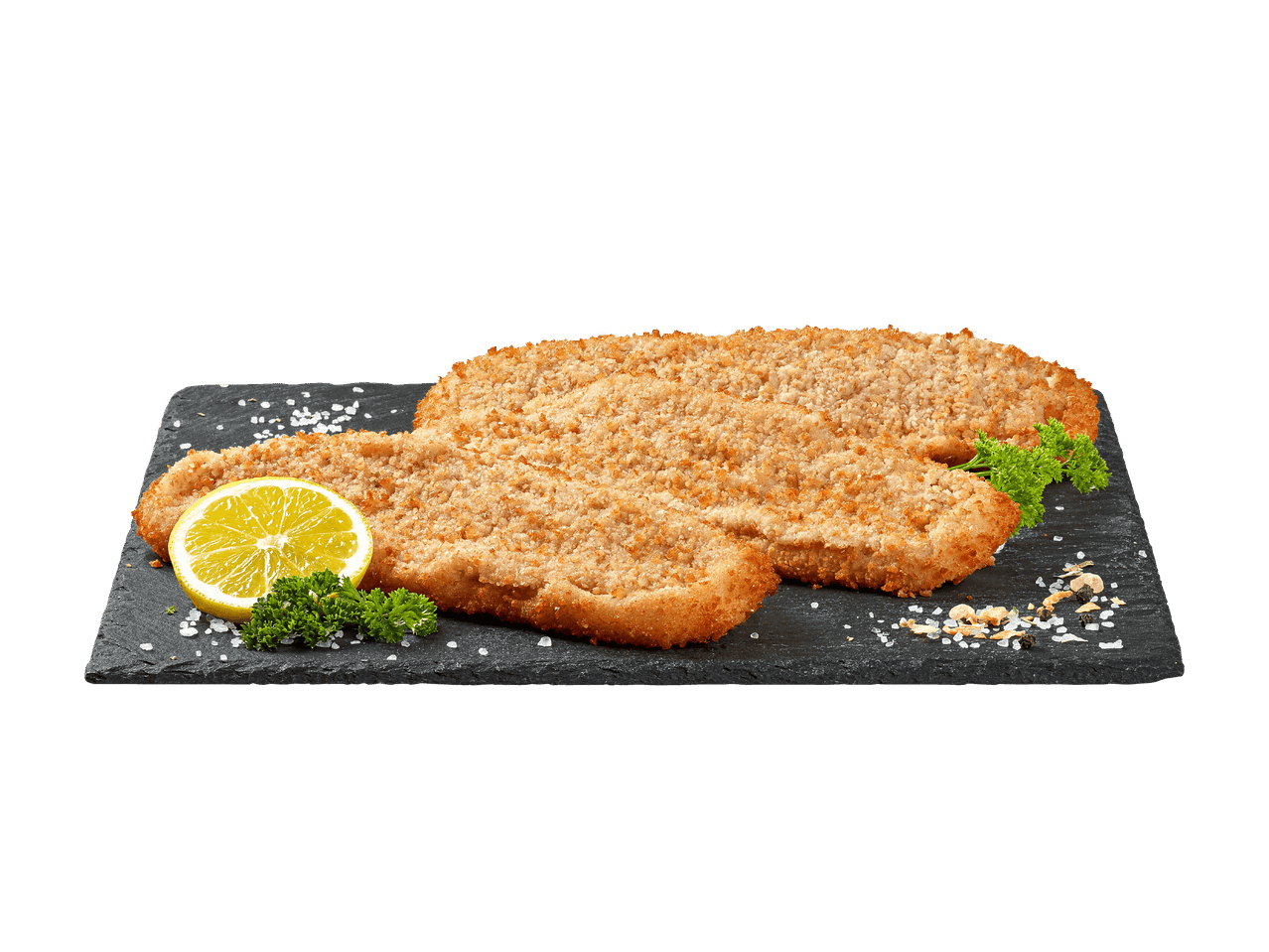Panierte Schnitzel auf einer Schieferplatte mit Zitrone und Petersilie