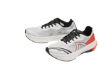 Crivit running shoes in white with black and orange accents.