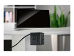 Laptop on a desk with an under-desk power strip featuring multiple outlets.