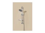Chrome shower set with a handheld showerhead spraying water, mounted on a beige wall.
