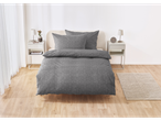 Gray duvet cover set with geometric pattern on a bed in a minimalist bedroom.