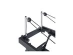 Close-up of a black and silver exercise machine with resistance bands and pulleys.