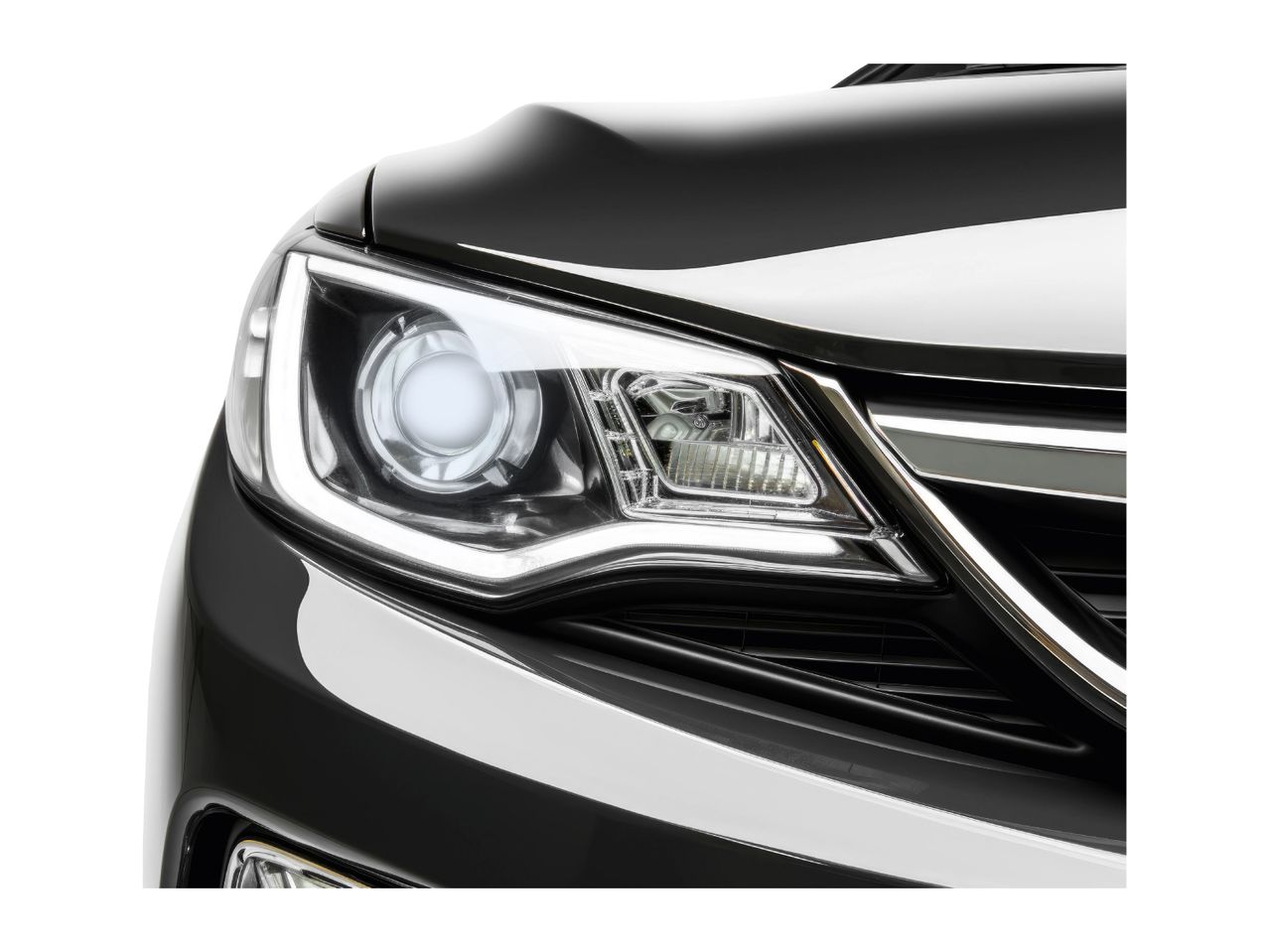 Close-up of a black car's headlight and front grille