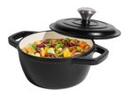 Black cast iron pot with lid, filled with a colorful stew of vegetables and beans.