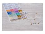 Bead organizer with colorful beads, charms, and a partially strung necklace on a wooden surface.