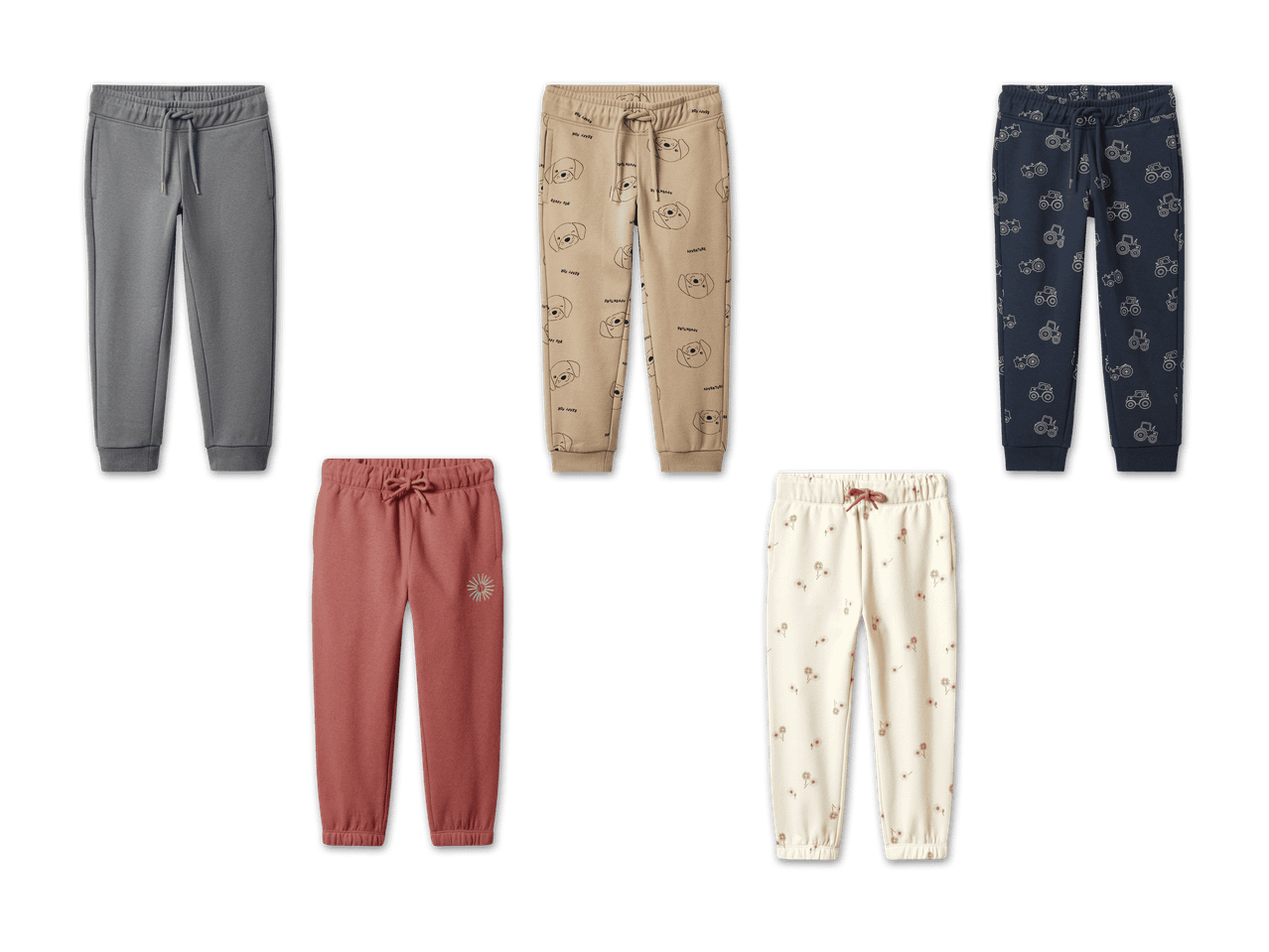 Fünf verschiedene Jogginghosen für Kinder, darunter einfarbige, gemusterte und bedruckte Designs.