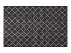 Black and white geometric patterned rug with a quatrefoil design.