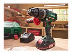A Parkside 20V cordless drill and battery charger sit on a workbench in a workshop.