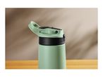 Close-up of a green water bottle with a black and green flip-top lid on a wooden surface.
