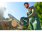 A man uses a Parkside chainsaw to cut a log.