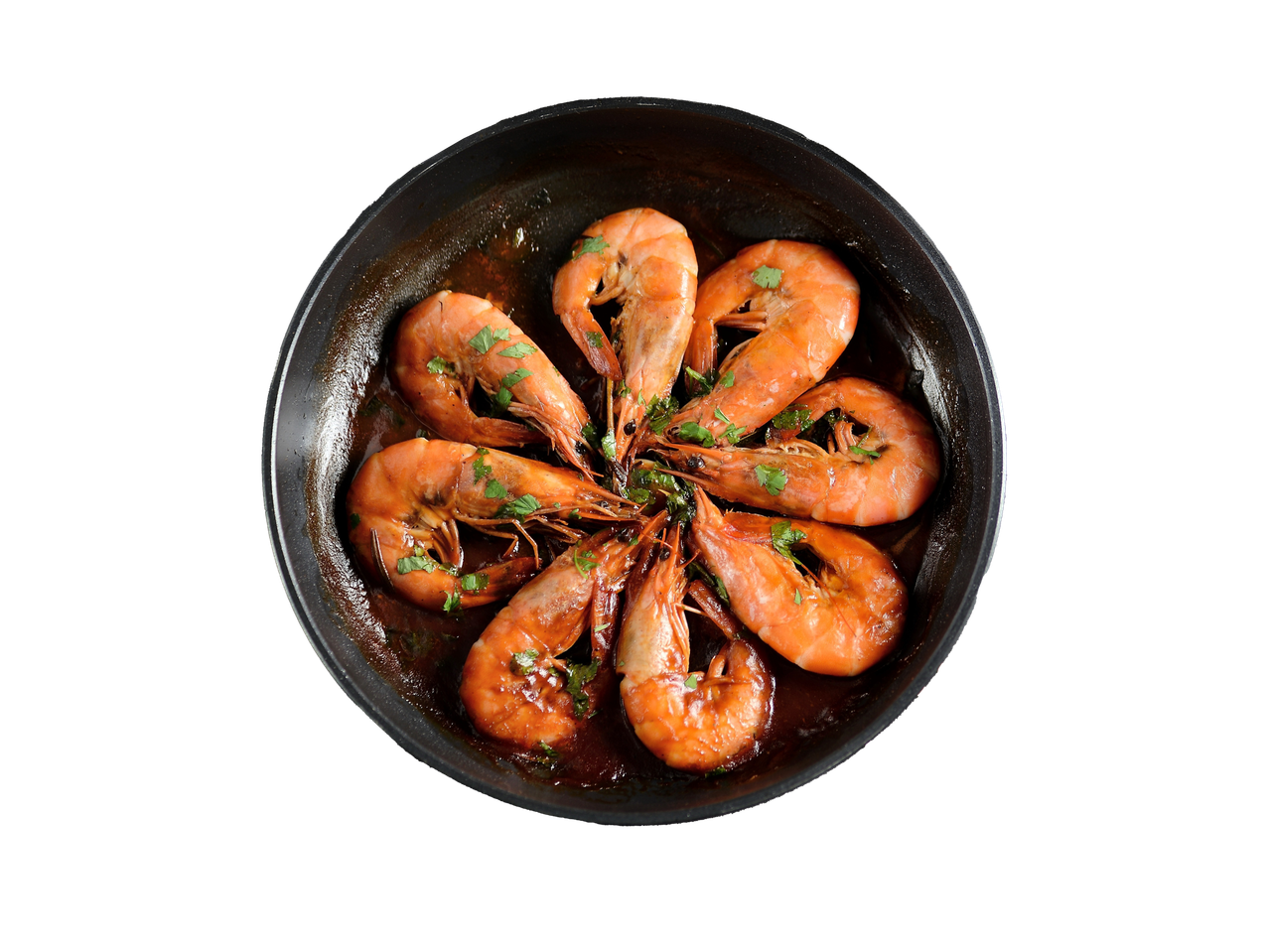 Praetud krevetid pannil, garneeritud peterselliga