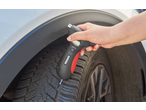 Handheld 5-in-1 tyre pressure gauge, measuring the tyre tread depth.