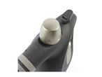 Close-up of a dark grey steam iron with a light grey temperature dial and an on/off switch.