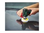 Hands polishing a car's surface with a compact, green and black electric polisher.