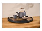 A dark grey teapot, a matching cup, and a small bowl of sugar cubes on a wooden serving tray.