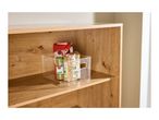 Clear storage box with lentils, spices, and a red bag on a wooden shelf.