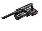 A dark gray and black handheld vacuum cleaner with a clear dustbin and a red battery pack.