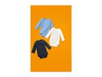 Three long-sleeved baby bodysuits in blue, white, and navy, arranged on an orange background.