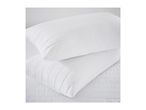 Two white quilted pillows on a white quilted mattress pad.
