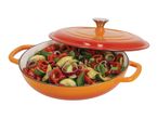 Orange cast iron Dutch oven filled with colorful roasted vegetables.