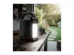 Portable work light on a wooden workbench with garden in the background.