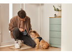 Man with Zoofari retractable dog lead and dog in a harness, ready for a walk.