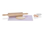 Wooden rolling pin and play dough on a baking mat with miniature eggs.