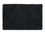 Rectangular black shag rug with a fluffy texture