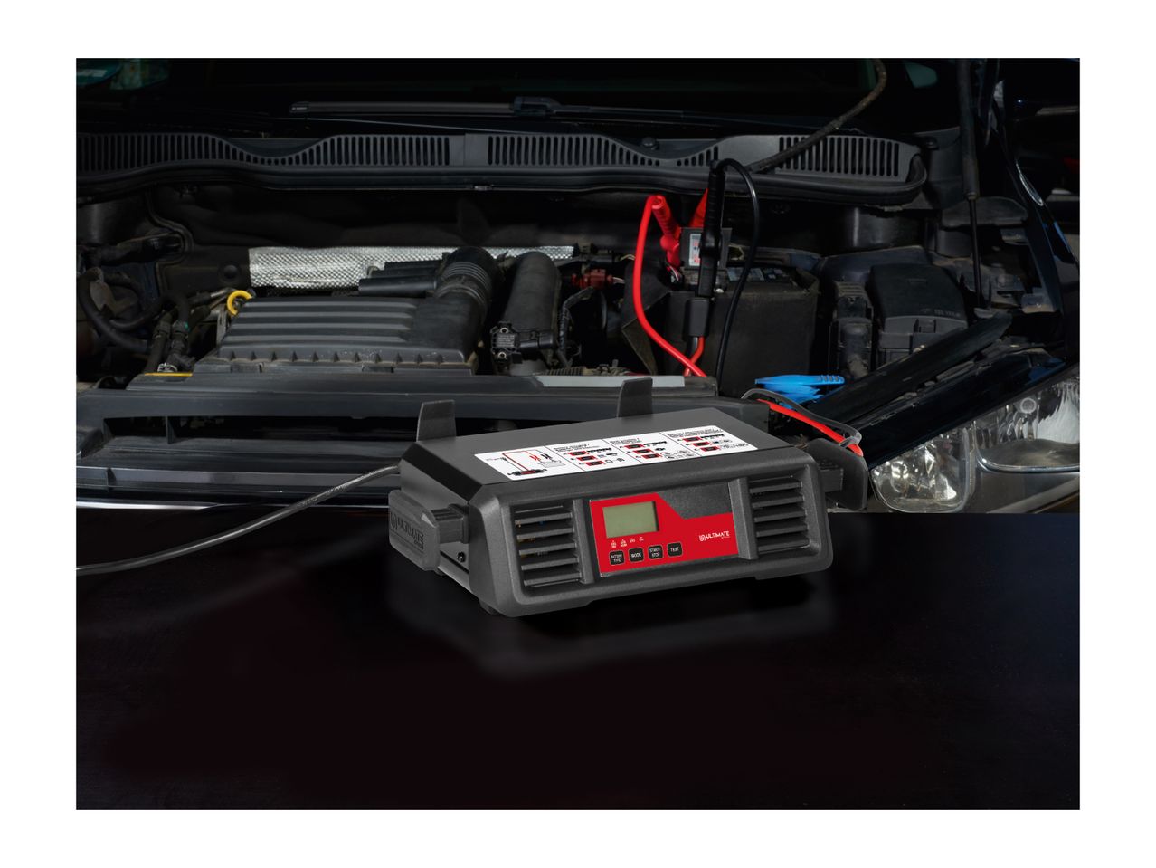Ultimate Speed car battery charger connected to a car engine.