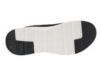 Bottom view of a black and white athletic shoe sole with textured grip patterns.
