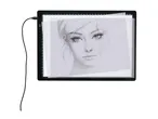 LED light pad with a drawing of a woman's face, connected by a black cable.