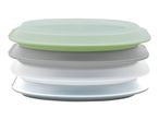 Stackable silicone food storage lids in green, gray, and white.