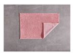 Pink bath mat on a gray tiled floor