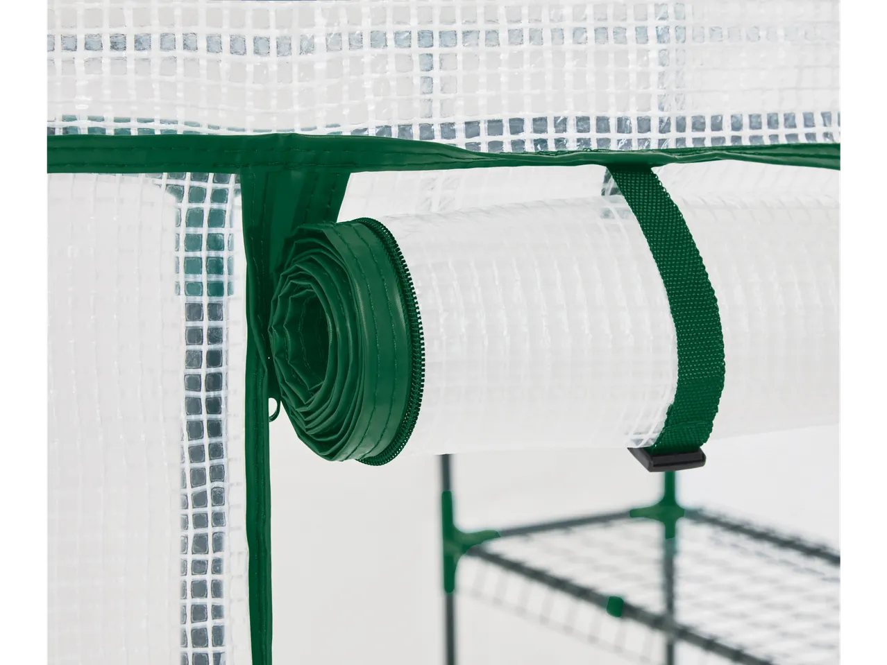 Parkside® Gewächshaus: Rolled-up transparent film with dark green zipper and strap.