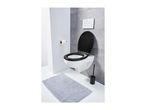 A modern bathroom with a wall-mounted toilet, black seat, toilet brush, and a gray bath mat.