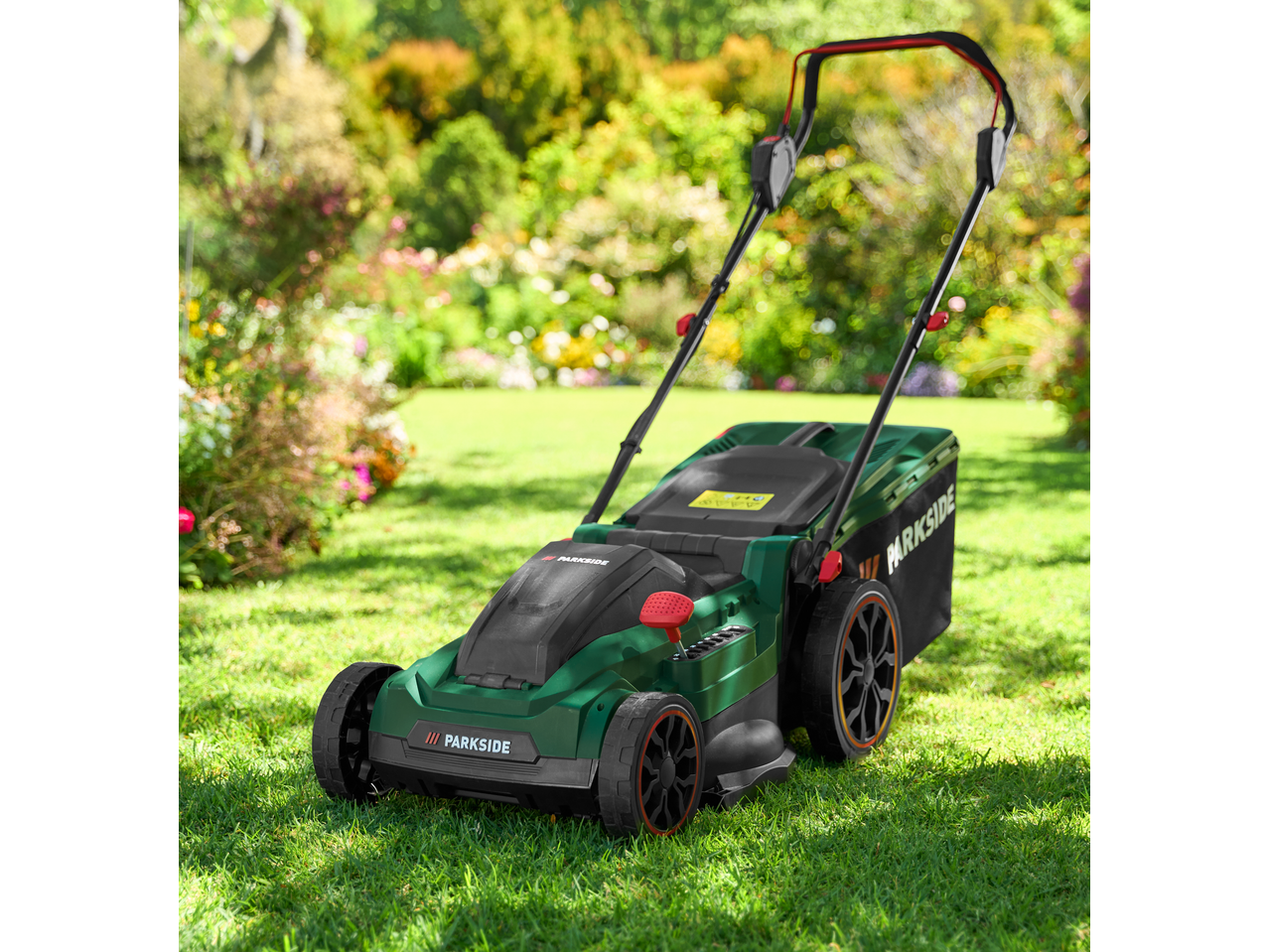 Parkside 40V Cordless Lawn Mower on green grass in a garden.