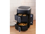 Dual-basket air fryer with chicken and fries, displaying 180°C on its digital screen.